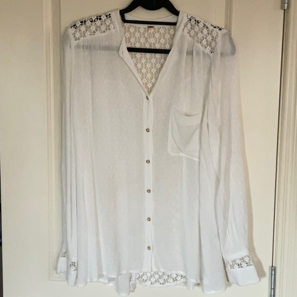 Ladies Free People blouse in white with beautifully crochet open back.